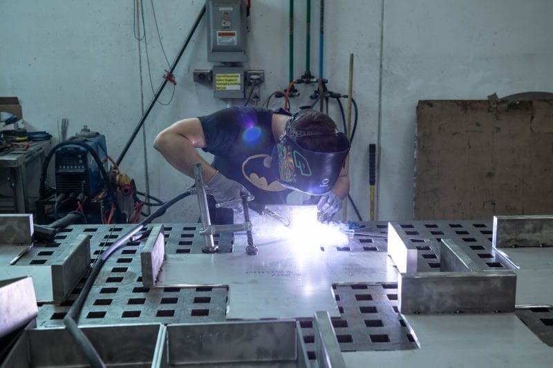 In-process TIG welding of stainless fixture components on precision fixturing table.