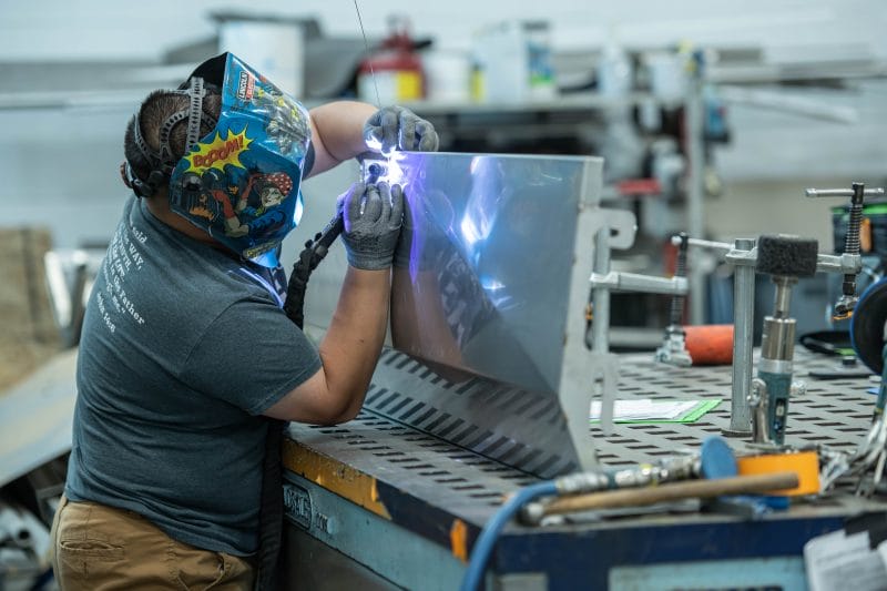 TIG welding of formed stainless enclosure with controlled heat input for surface consistency.